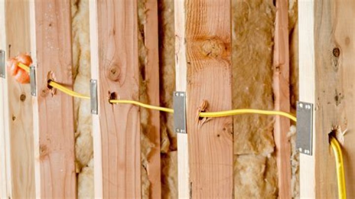 Can you run electrical wire through wall studs?