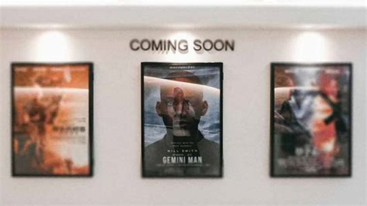 How do film posters attract audiences?